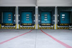 five blue shipping doors at a warehouse